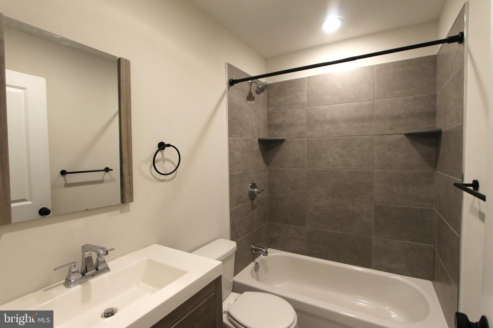 492 Roxborough Avenue, Unit 403 Philadelphia, PA 19128 - Photo 16 of 28 a bathroom with a sink and a mirror
