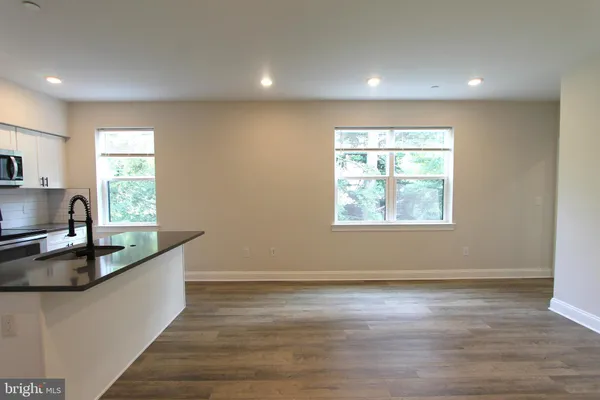 a kitchen with granite countertop a sink and a window