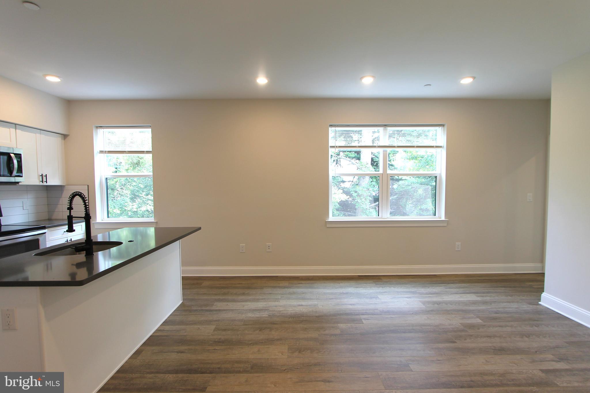 492 Roxborough Avenue, Unit 403 Philadelphia, PA 19128 - Photo 2 of 28 a kitchen with granite countertop a sink and a window