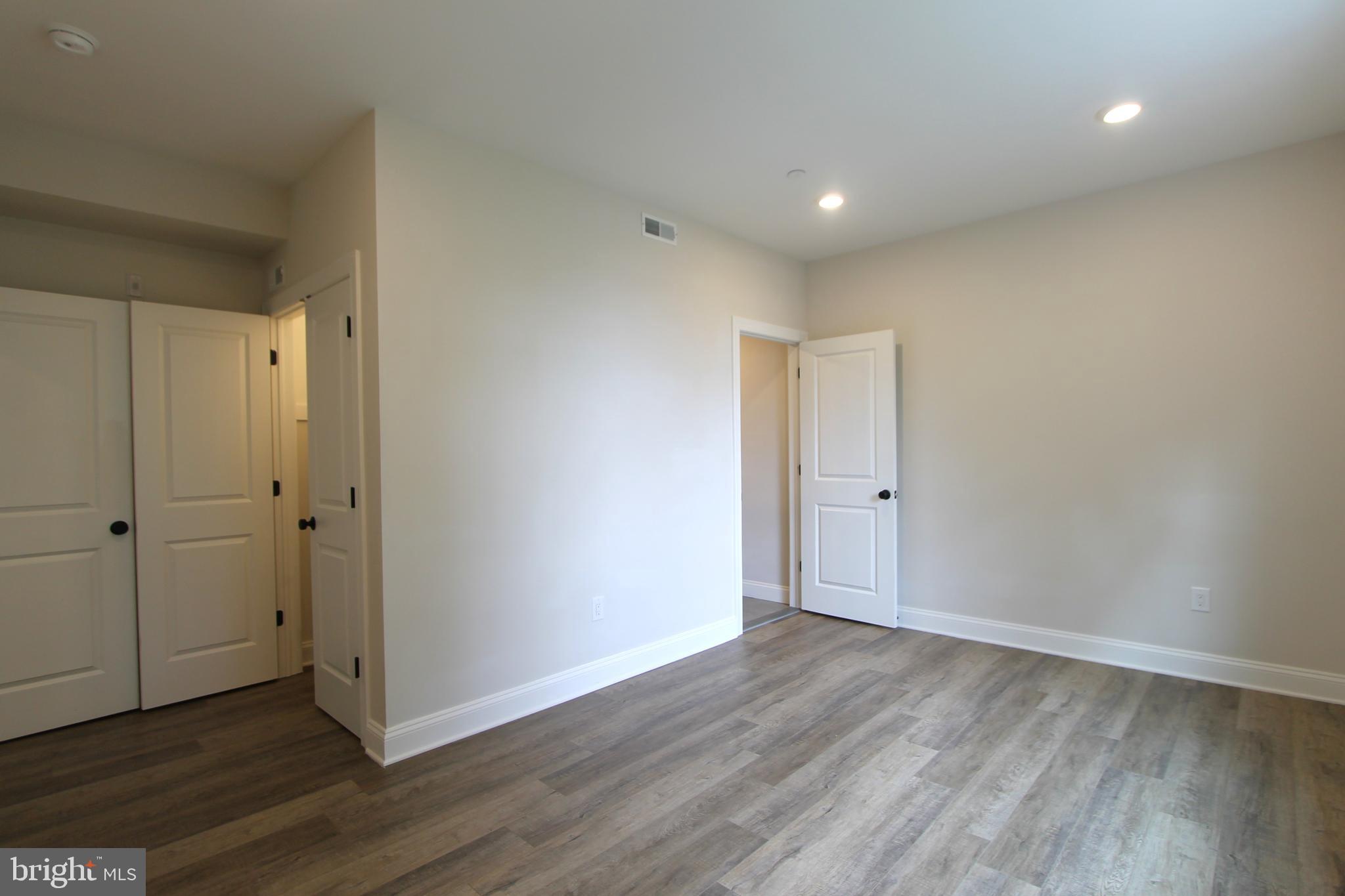 492 Roxborough Avenue, Unit 403 Philadelphia, PA 19128 - Photo 21 of 28 a view of an empty room with wooden floor