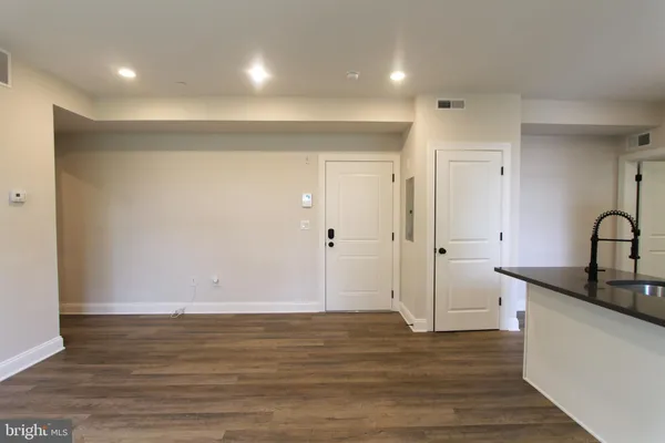 a view of a room with wooden floor