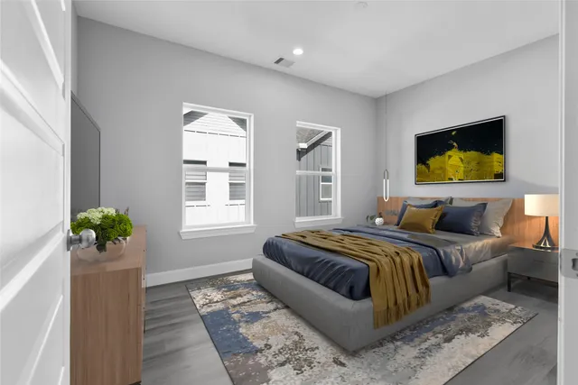 a bedroom with bed couch and window