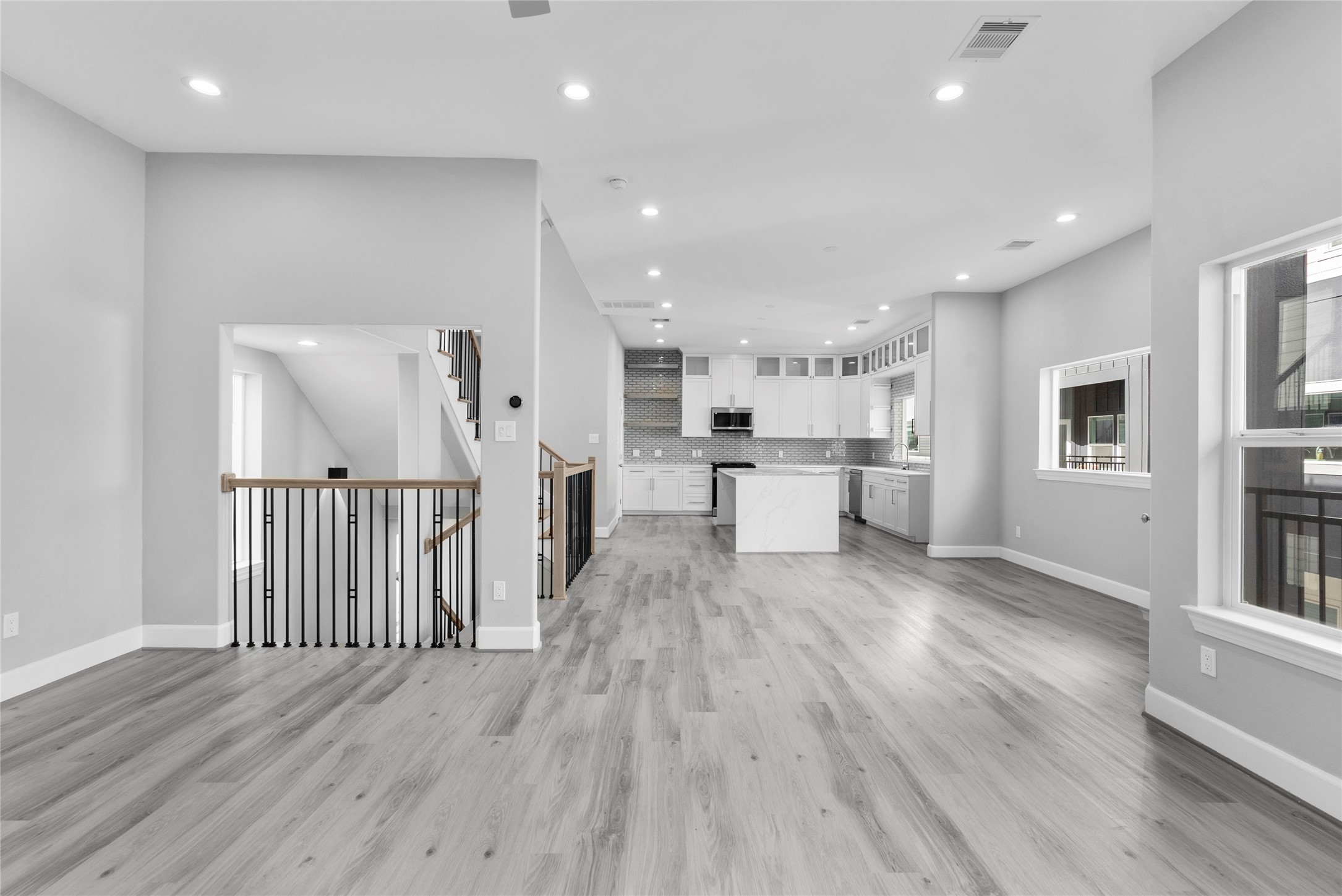 1122 West 16th Street, Unit B Houston, TX 77008 - Photo 9 of 31 a view of kitchen with refrigerator microwave and wooden floor