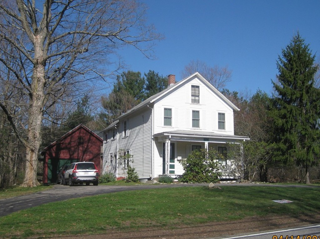 634 Edgell Road Framingham, MA 01701 - Photo 1 of 6 a front view of a house with a garden
