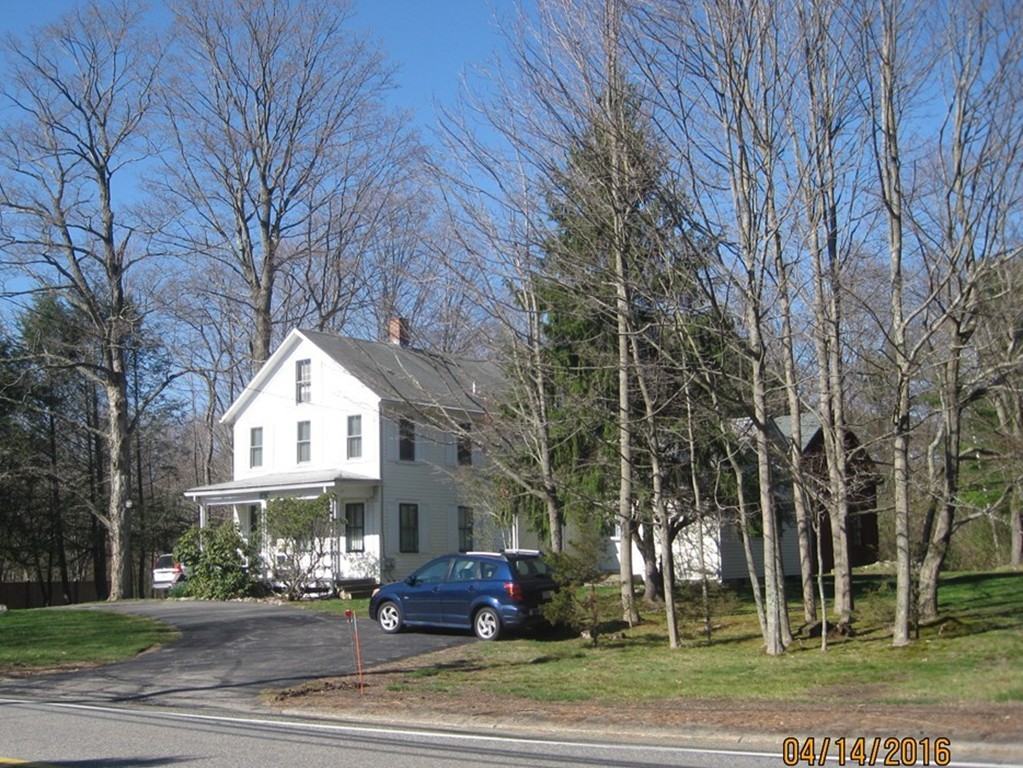 634 Edgell Road Framingham, MA 01701 - Photo 2 of 6 a view of a big house with a big yard and large trees