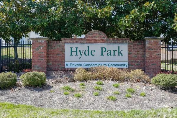 a sign broad in front of a red brick house