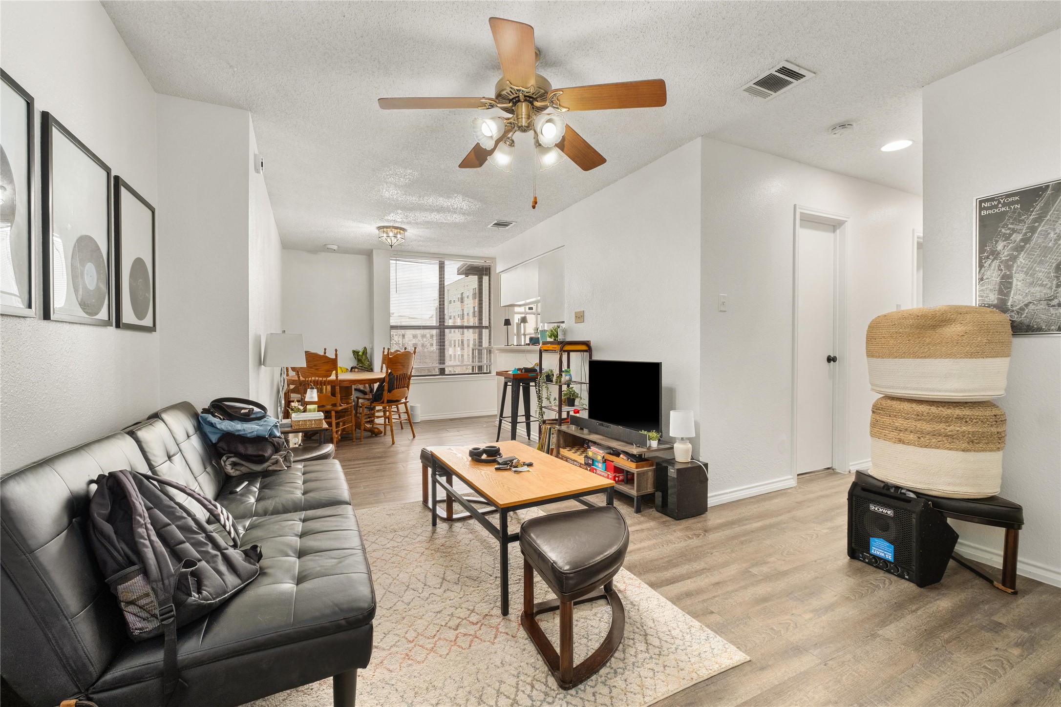 2409 Leon Street, Unit 307 Austin, TX 78705 - Photo 1 of 23 a living room with furniture and a flat screen tv