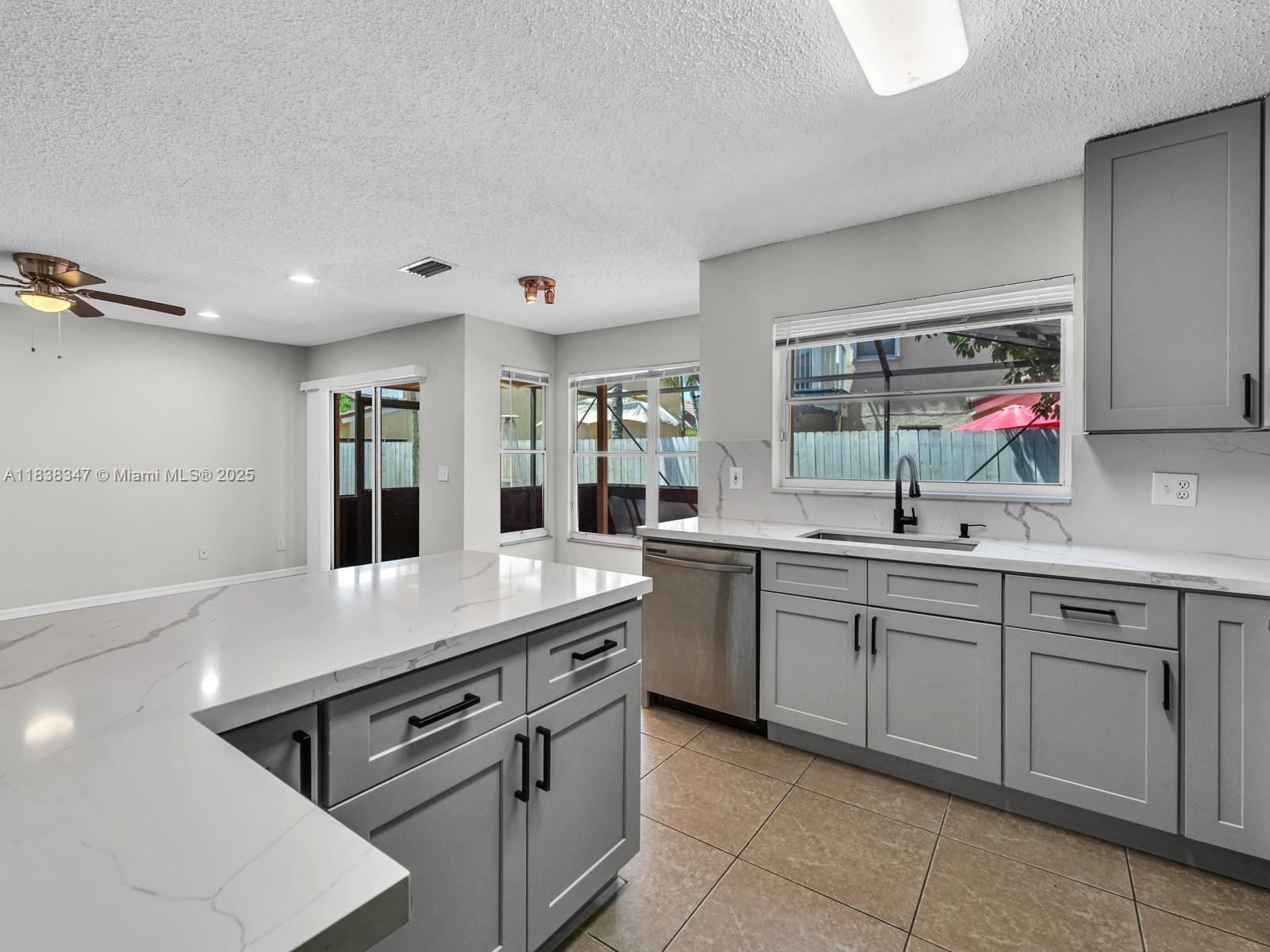 18232 Southwest 5th Street Pembroke Pines, FL 33029 - Photo 14 of 53 a kitchen with stainless steel appliances granite countertop a sink and white cabinets