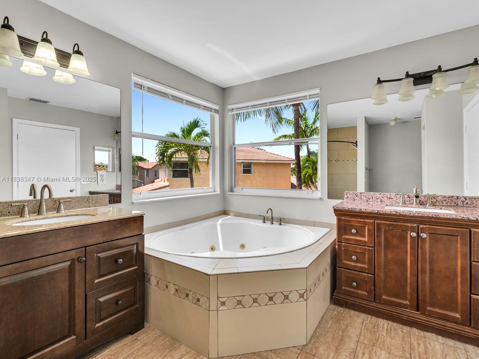 18232 Southwest 5th Street Pembroke Pines, FL 33029 - Photo 21 of 53 a spacious bathroom with a sink double vanity and a mirror