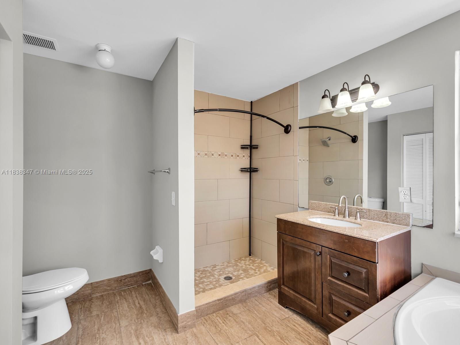 18232 Southwest 5th Street Pembroke Pines, FL 33029 - Photo 22 of 53 a bathroom with a sink a toilet and shower