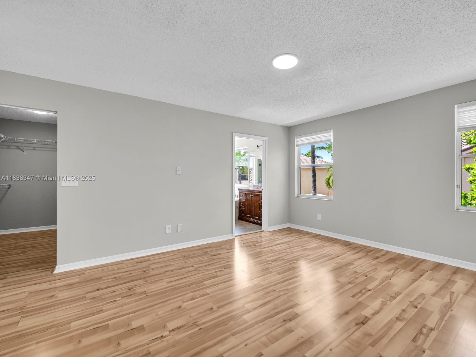 18232 Southwest 5th Street Pembroke Pines, FL 33029 - Photo 23 of 53 a view of an empty room with window and wooden floor