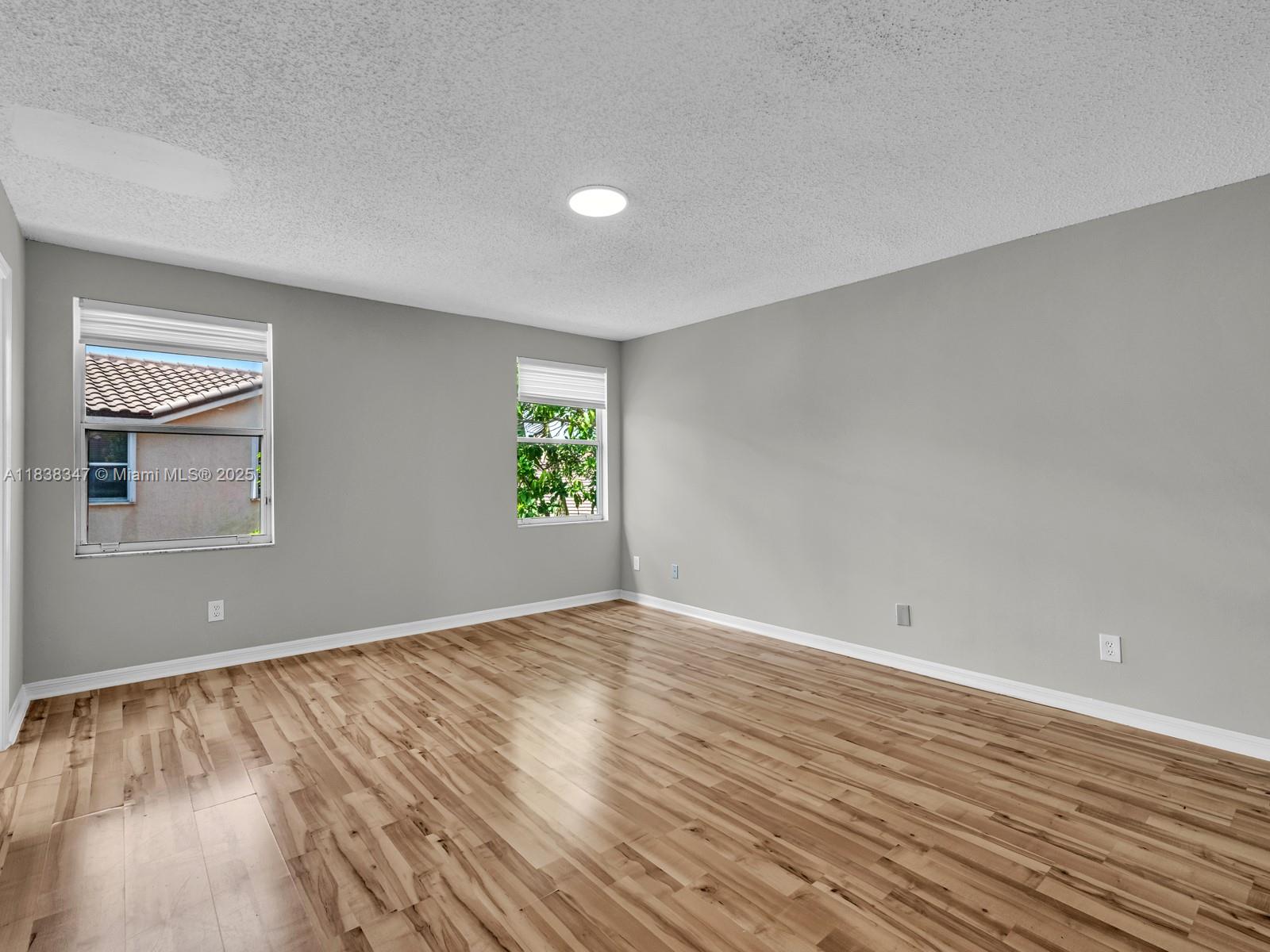 18232 Southwest 5th Street Pembroke Pines, FL 33029 - Photo 24 of 53 wooden floor in an empty room with a window