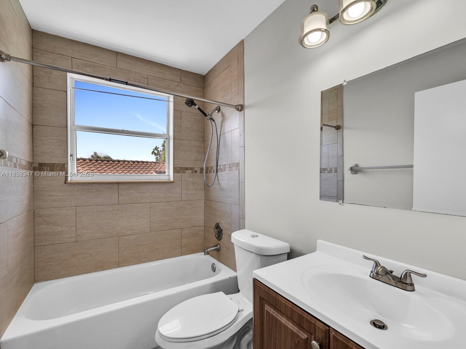 18232 Southwest 5th Street Pembroke Pines, FL 33029 - Photo 28 of 53 a bathroom with a sink toilet and bathtub