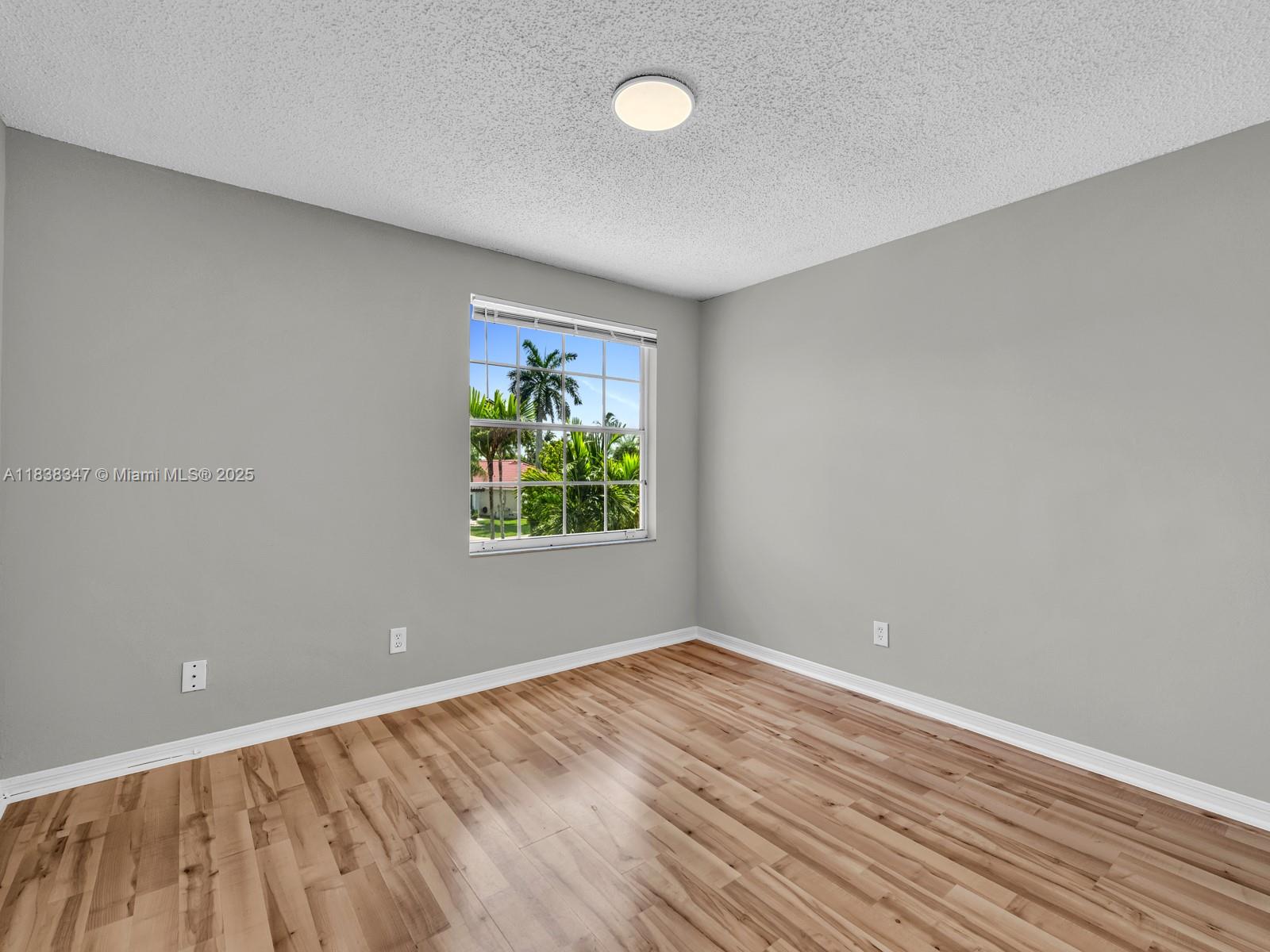 18232 Southwest 5th Street Pembroke Pines, FL 33029 - Photo 30 of 53 wooden floor in an empty room with a window