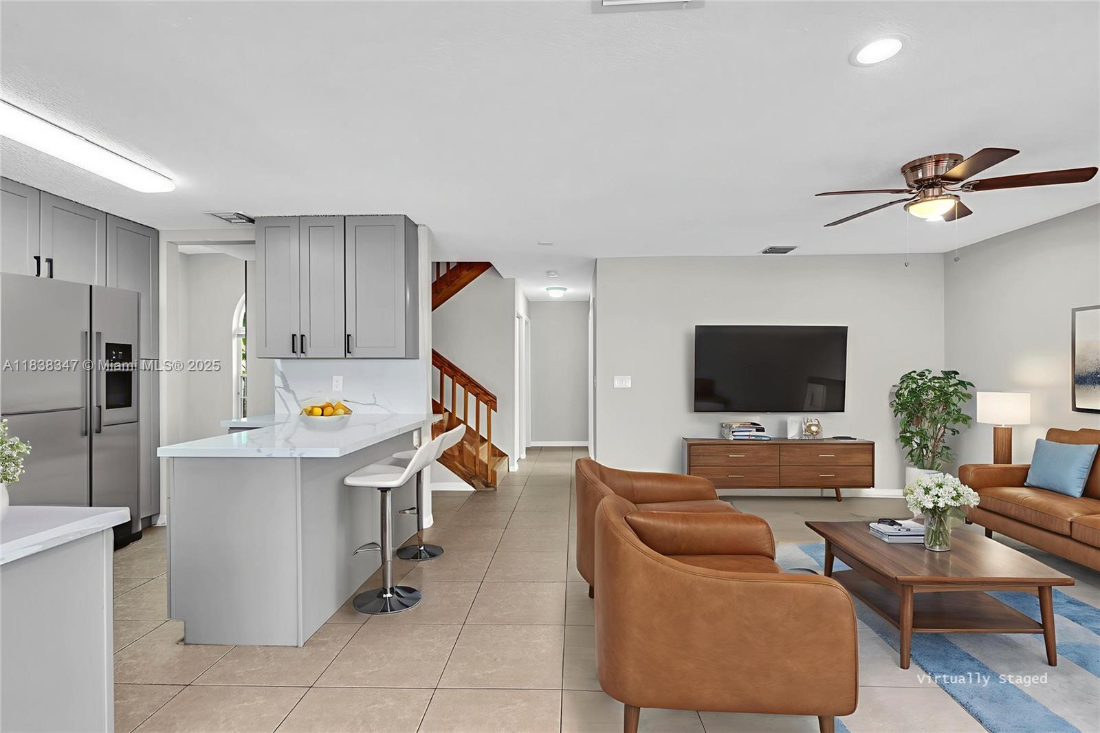 18232 Southwest 5th Street Pembroke Pines, FL 33029 - Photo 4 of 53 a living room with furniture and a flat screen tv