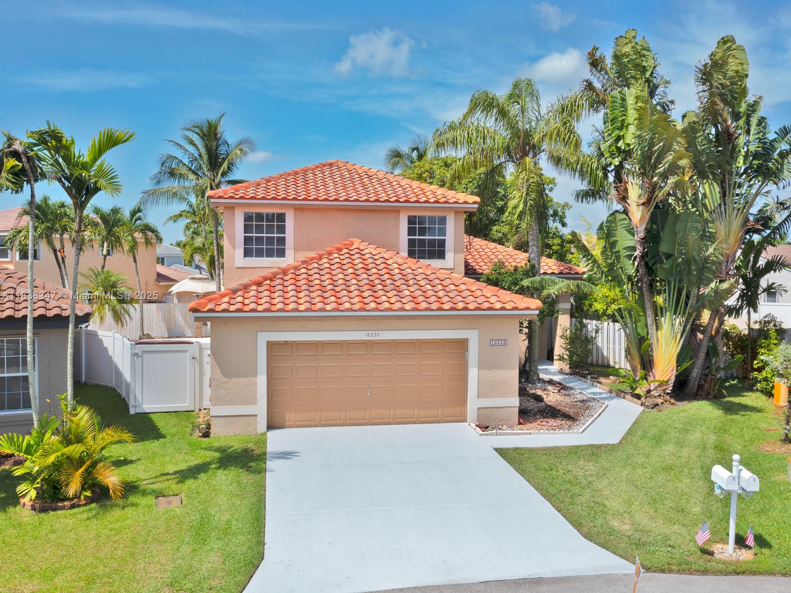 18232 Southwest 5th Street Pembroke Pines, FL 33029 - Photo 48 of 53 a front view of a house with a yard