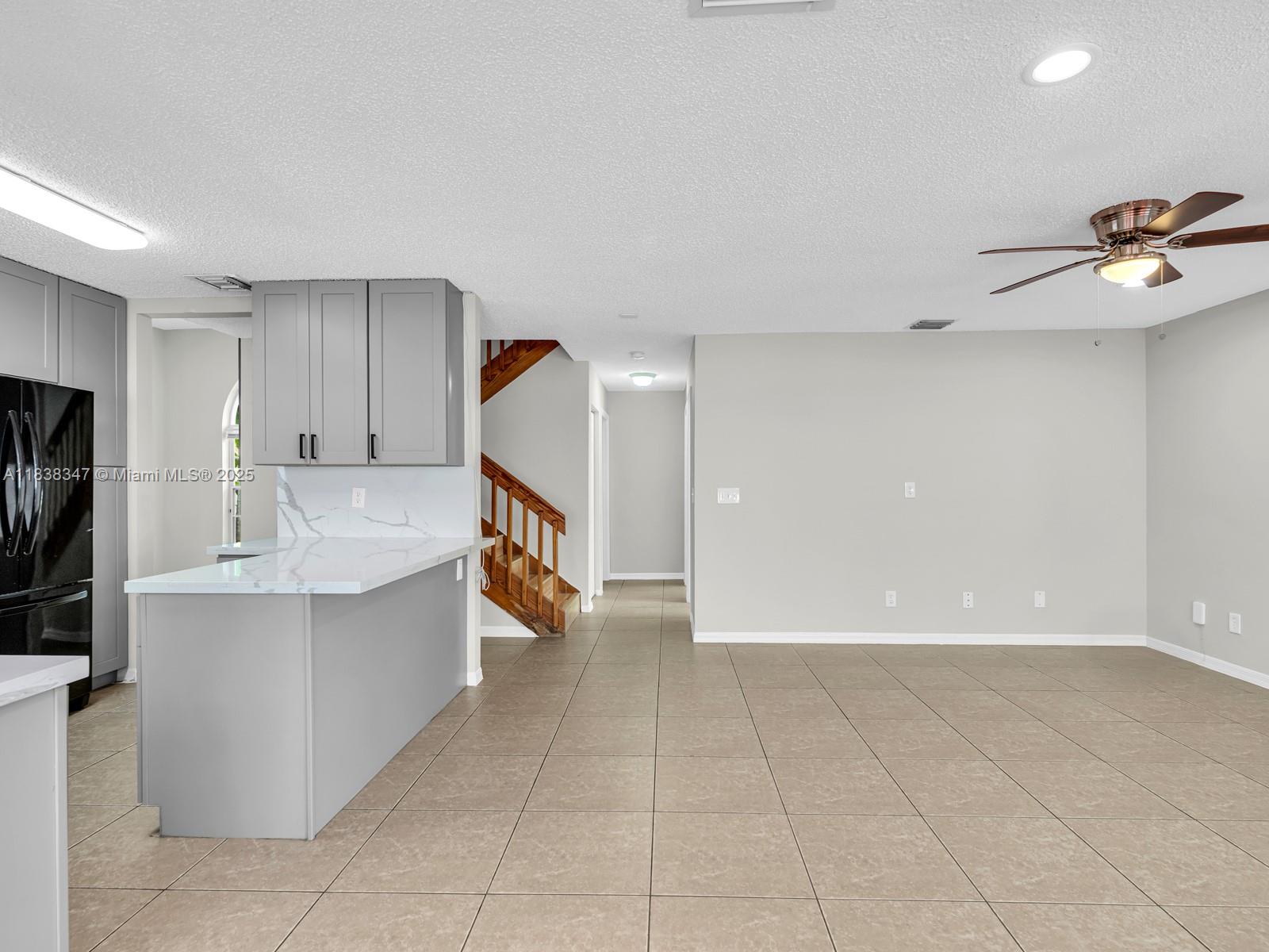 18232 Southwest 5th Street Pembroke Pines, FL 33029 - Photo 9 of 53 a view of a kitchen with a sink and a refrigerator