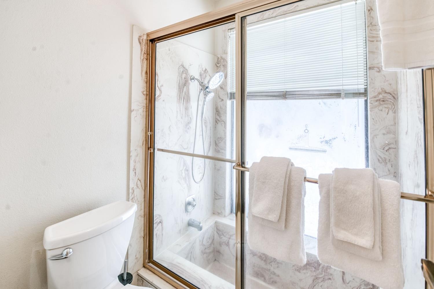 39145 Checkerbloom Lane Shaver Lake, CA 93664 - Photo 15 of 58 a bathroom with a glass shower door