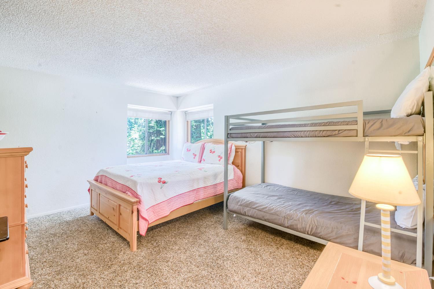 39145 Checkerbloom Lane Shaver Lake, CA 93664 - Photo 17 of 58 a bedroom with a bed and a window