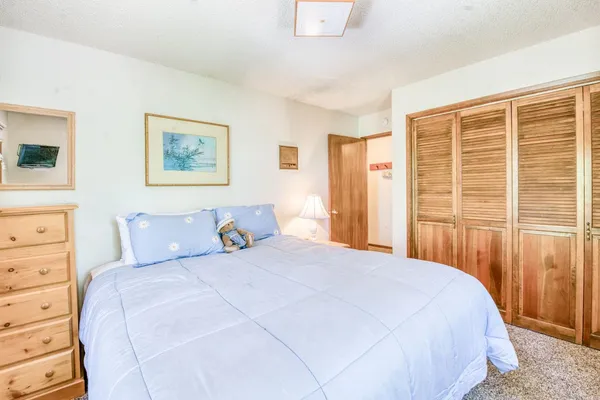 a bedroom with a bed and a large window