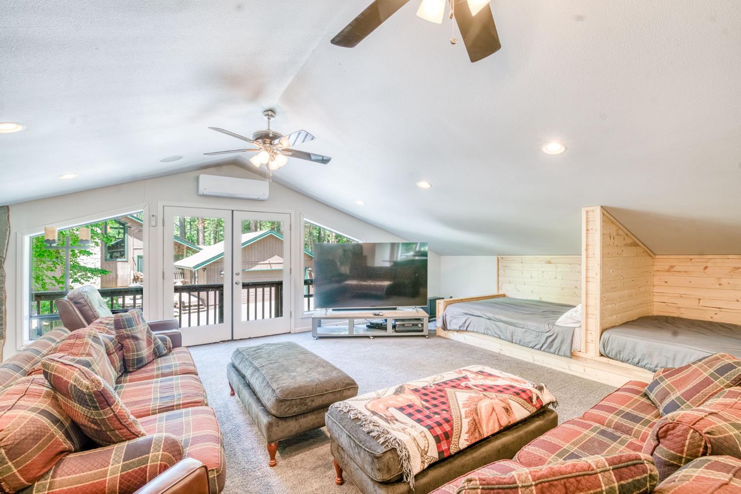 39145 Checkerbloom Lane Shaver Lake, CA 93664 - Photo 30 of 58 a living room with furniture ceiling fan and a large window