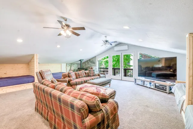 a view of a dining room with furniture and a large window