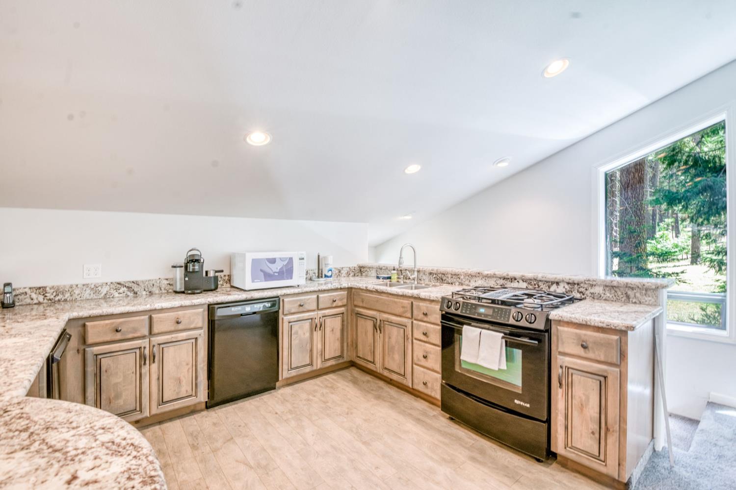 39145 Checkerbloom Lane Shaver Lake, CA 93664 - Photo 34 of 58 a kitchen with stainless steel appliances granite countertop a stove a sink and a refrigerator