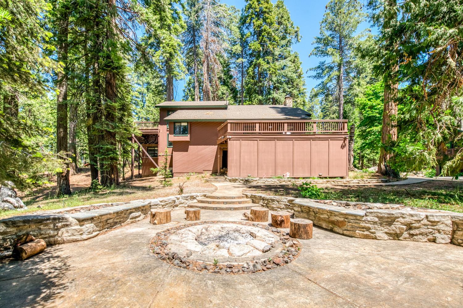 39145 Checkerbloom Lane Shaver Lake, CA 93664 - Photo 42 of 58 a view of a backyard with a trees