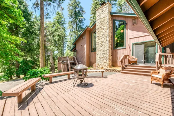a view of a house with backyard and sitting area
