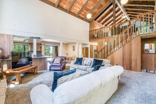 a living room with furniture a fireplace and a large window
