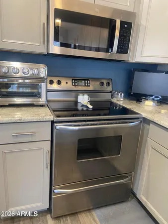 a stove top oven sitting inside of a kitchen
