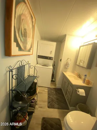 a bathroom with a sink mirror vanity and toilet