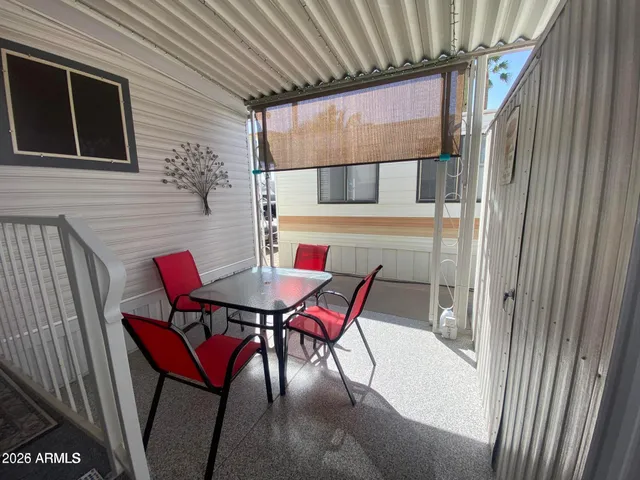 a balcony with table and chairs