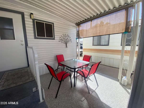 a patio with a table and chairs