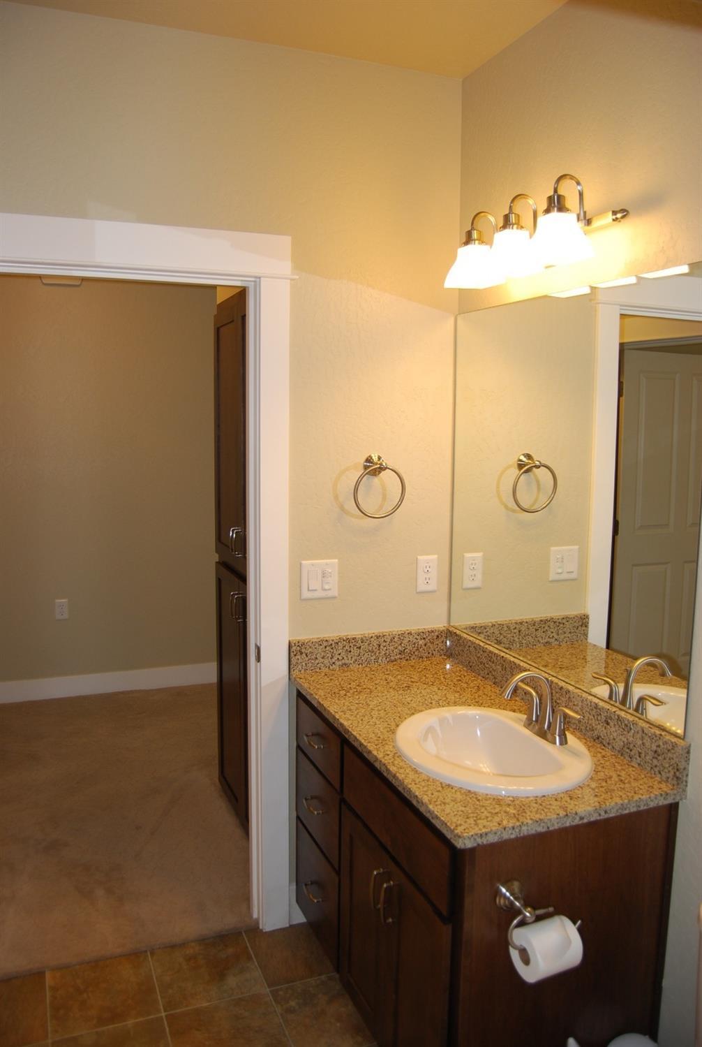 1171 North Haskell Street Central Point, OR 97502 - Photo 17 of 19 a bathroom with a sink and a mirror