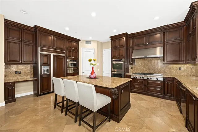 a utility room with granite countertop cabinets washer and dryer