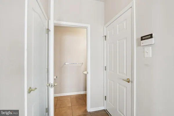 a bedroom with a large bed and a flat tv screen on dresser