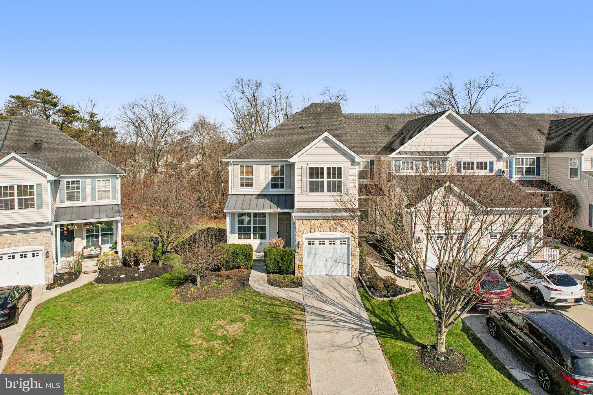 24 Compass Circle Mount Laurel, NJ 08054 - Photo 3 of 61 a view of a big yard in front of a brick house with large windows