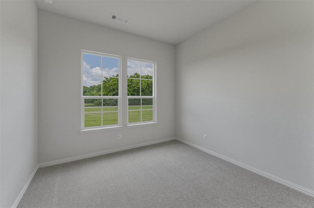 8861 County Road 623 Blue Ridge, TX 75424 - Photo 13 of 25 Neutral-toned room featuring a light gray wall finish, gray carpeting, and white baseboards