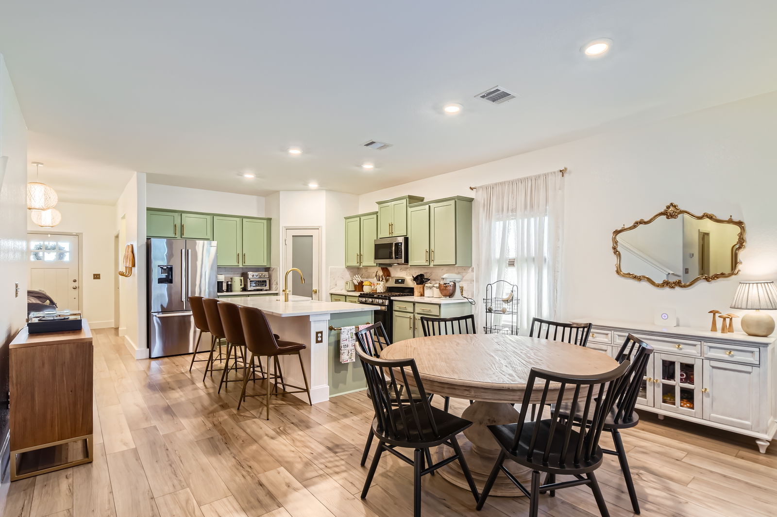 261 Mendoza Kyle, TX 78640 - Photo 10 of 28 a view of a dining room with furniture and wooden floor