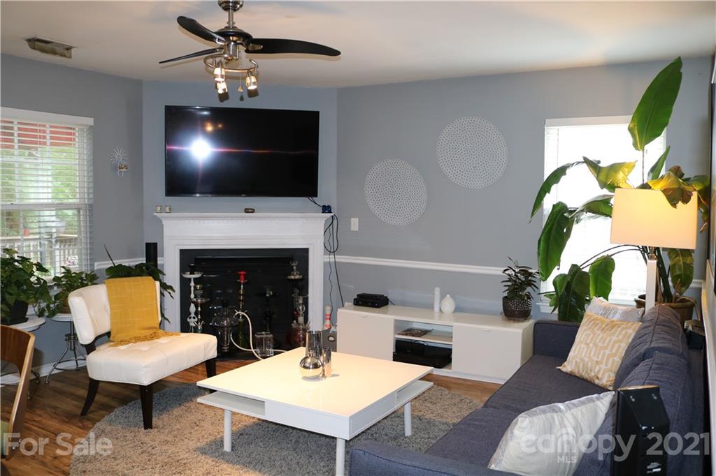 6414 Nevin Road Charlotte, NC 28262 - Photo 11 of 17 a living room with furniture a flat screen tv and a fireplace