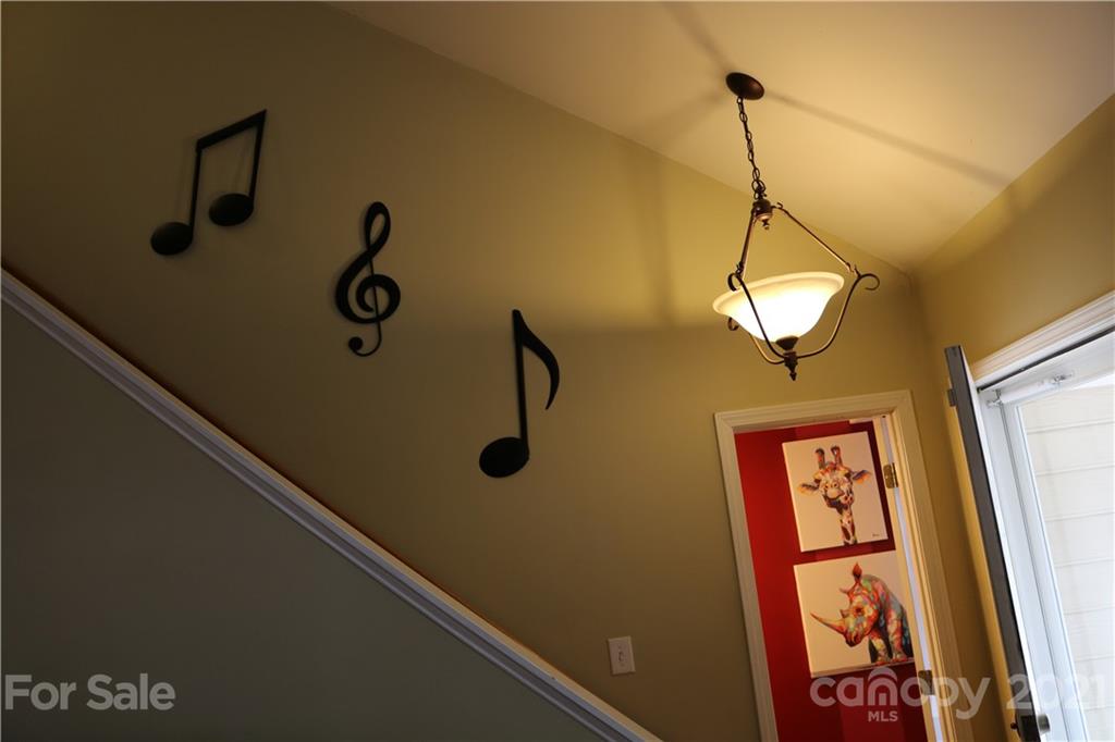 6414 Nevin Road Charlotte, NC 28262 - Photo 13 of 17 a view of a hallway with paintings on the wall