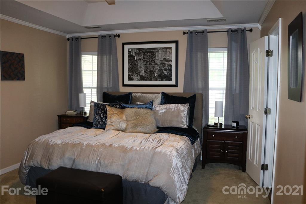 6414 Nevin Road Charlotte, NC 28262 - Photo 15 of 17 a bedroom with a bed a dresser and a window