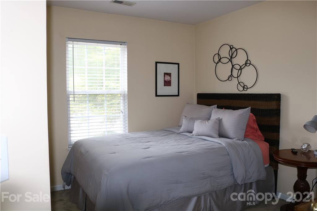 6414 Nevin Road Charlotte, NC 28262 - Photo 16 of 17 a bedroom with a bed and two windows