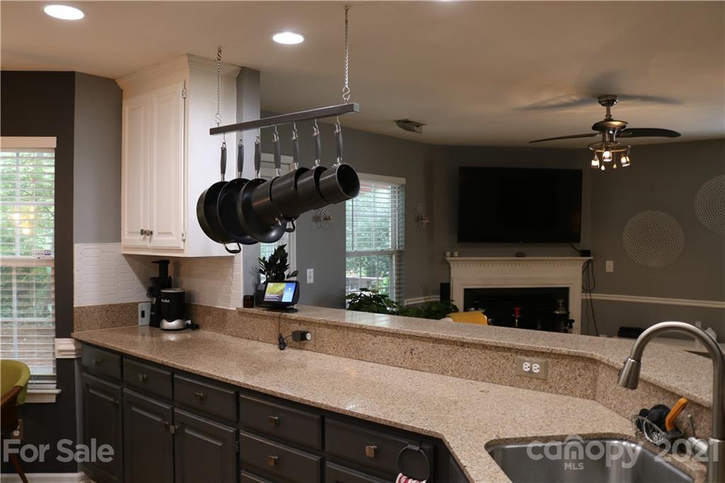 6414 Nevin Road Charlotte, NC 28262 - Photo 10 of 17 a kitchen with a sink stainless steel appliances and cabinets