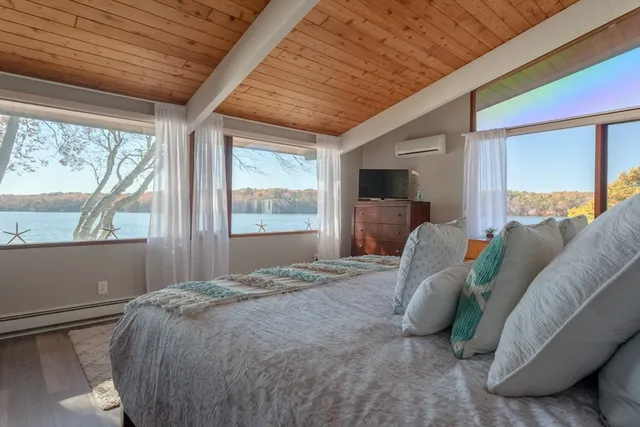 a bed sitting in a bedroom next to a window