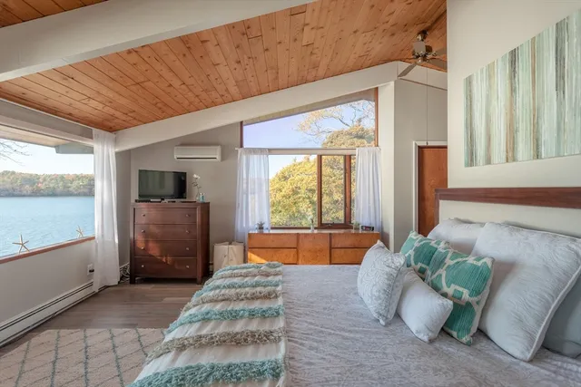 a bed room with furniture and a large window