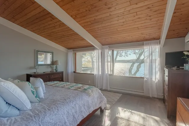 a bedroom with a bed and a large window