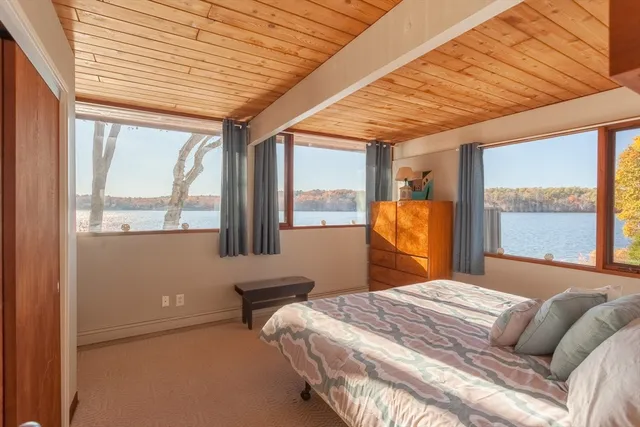 a bedroom with a large bed and a window