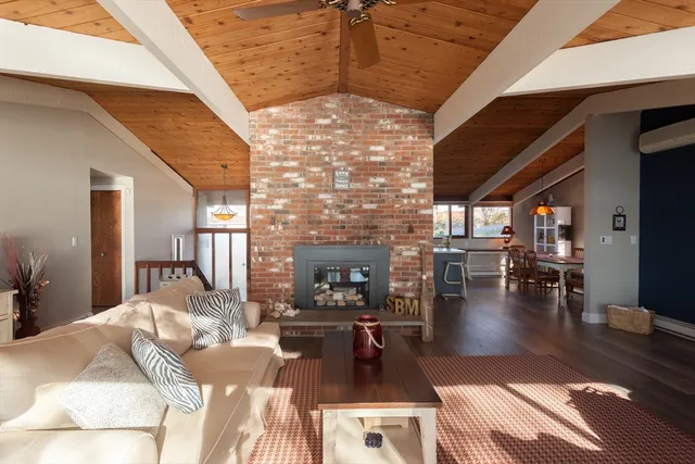 a living room with fireplace furniture and a wooden floor